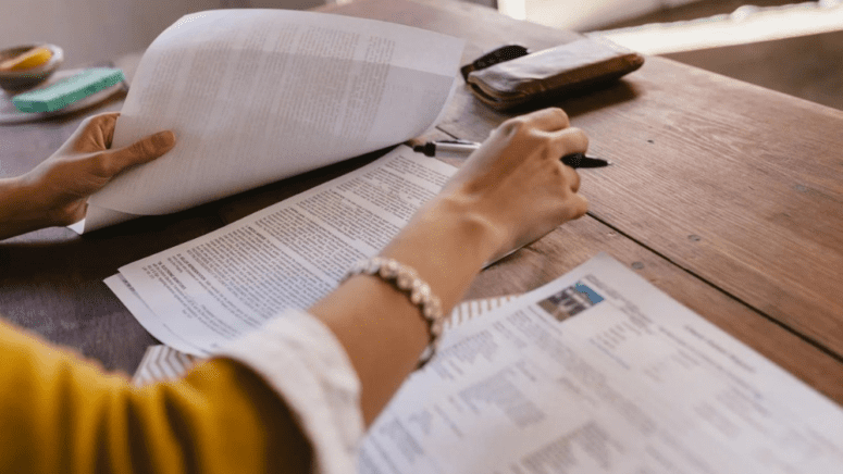 A woman reviewing an offer to purchase real estate.