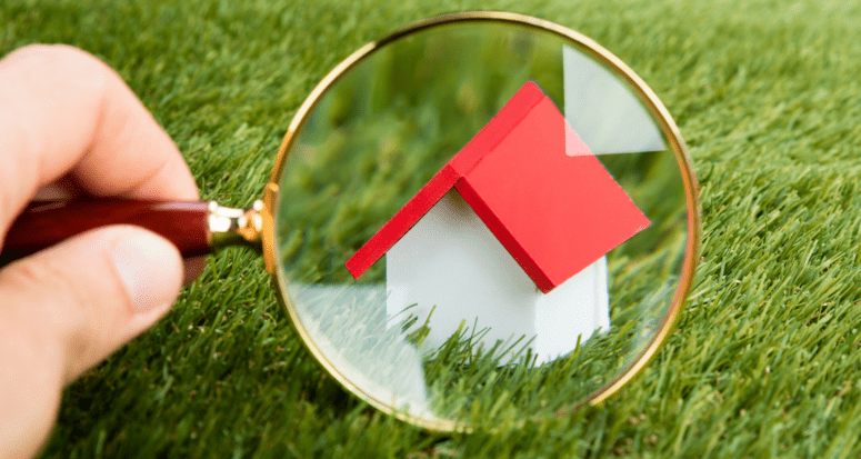 A magnifying glass over a new construction home.