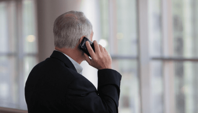 A photos of a man on.a cell phone illustrates an agent working hard for their seller clients.