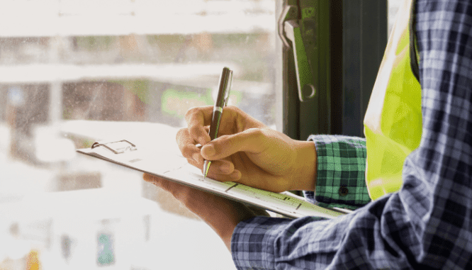 An image of a man checking his due diligence real estate checklist.