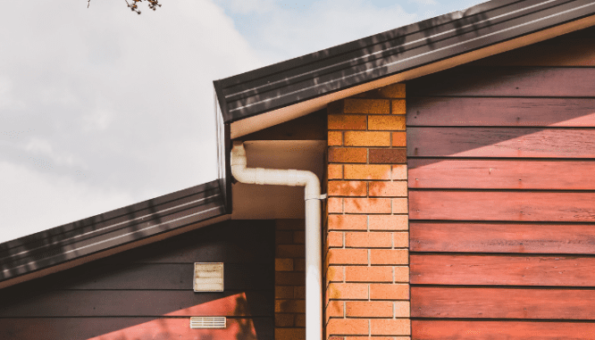 The roof and gutter of a house, both of which should be part of your new construction checklist inspections.