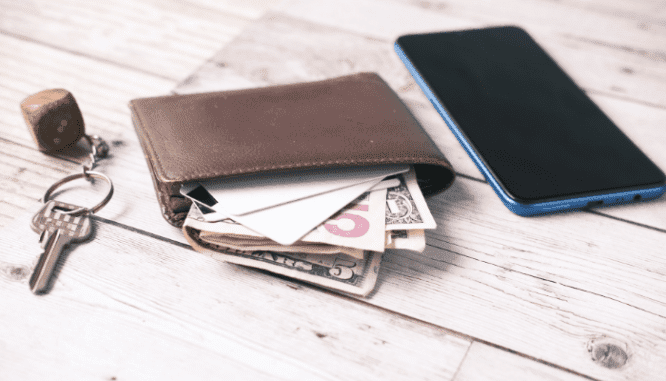 A wallet with cash used to buy real estate.