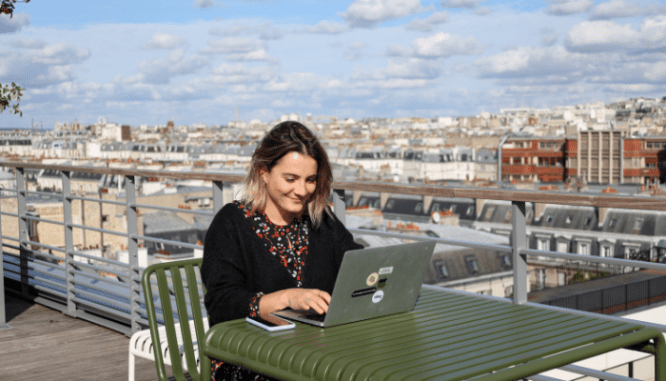 A woman looking for real estate agents on her laptop to help with new construction.