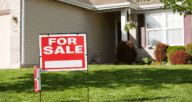 A for sale sign in front of a house that's selling by owner.