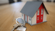 An image of a model house aand key that represents house pricing strategies