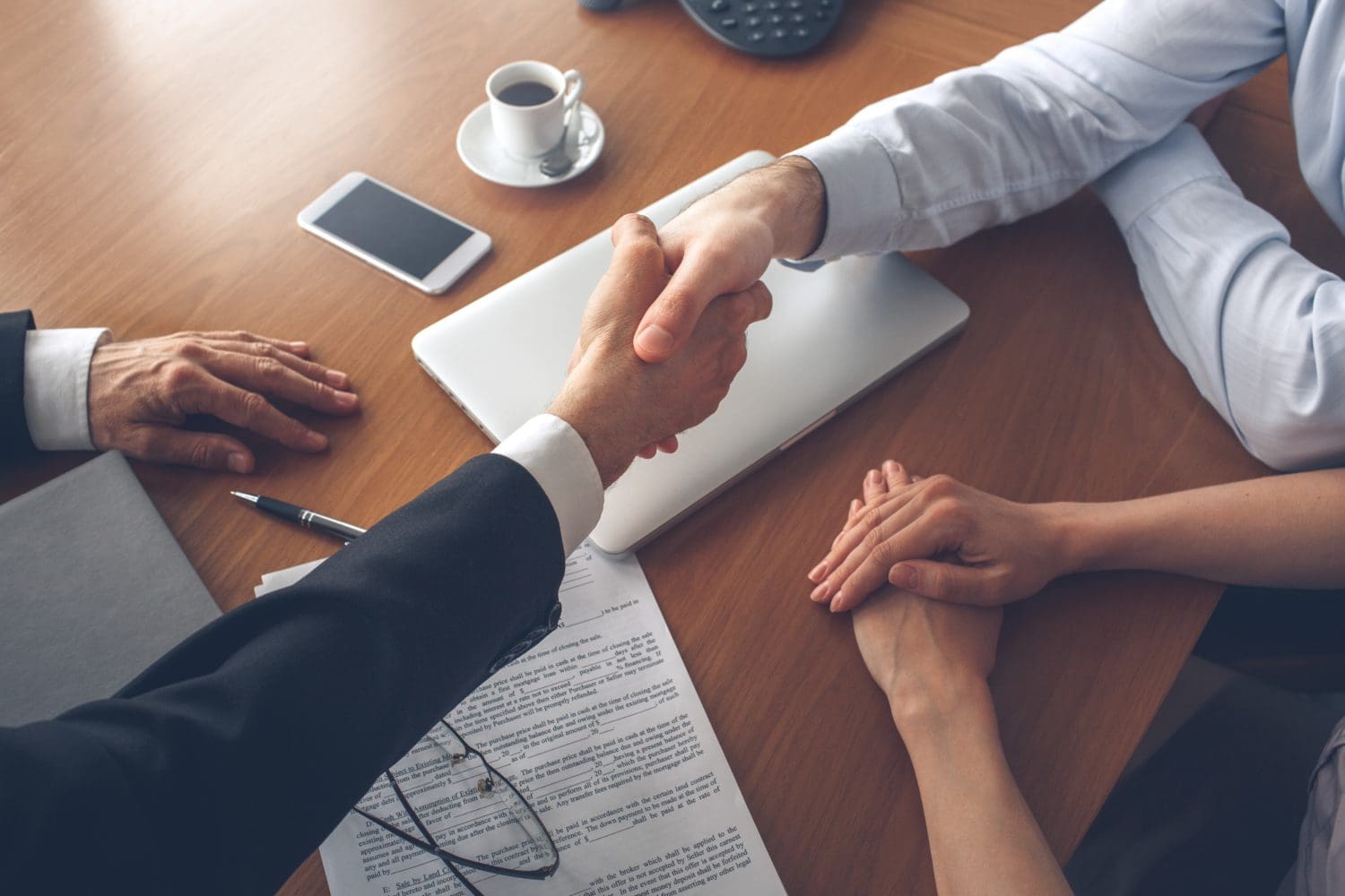A handshake symbolizing cash payment for a house